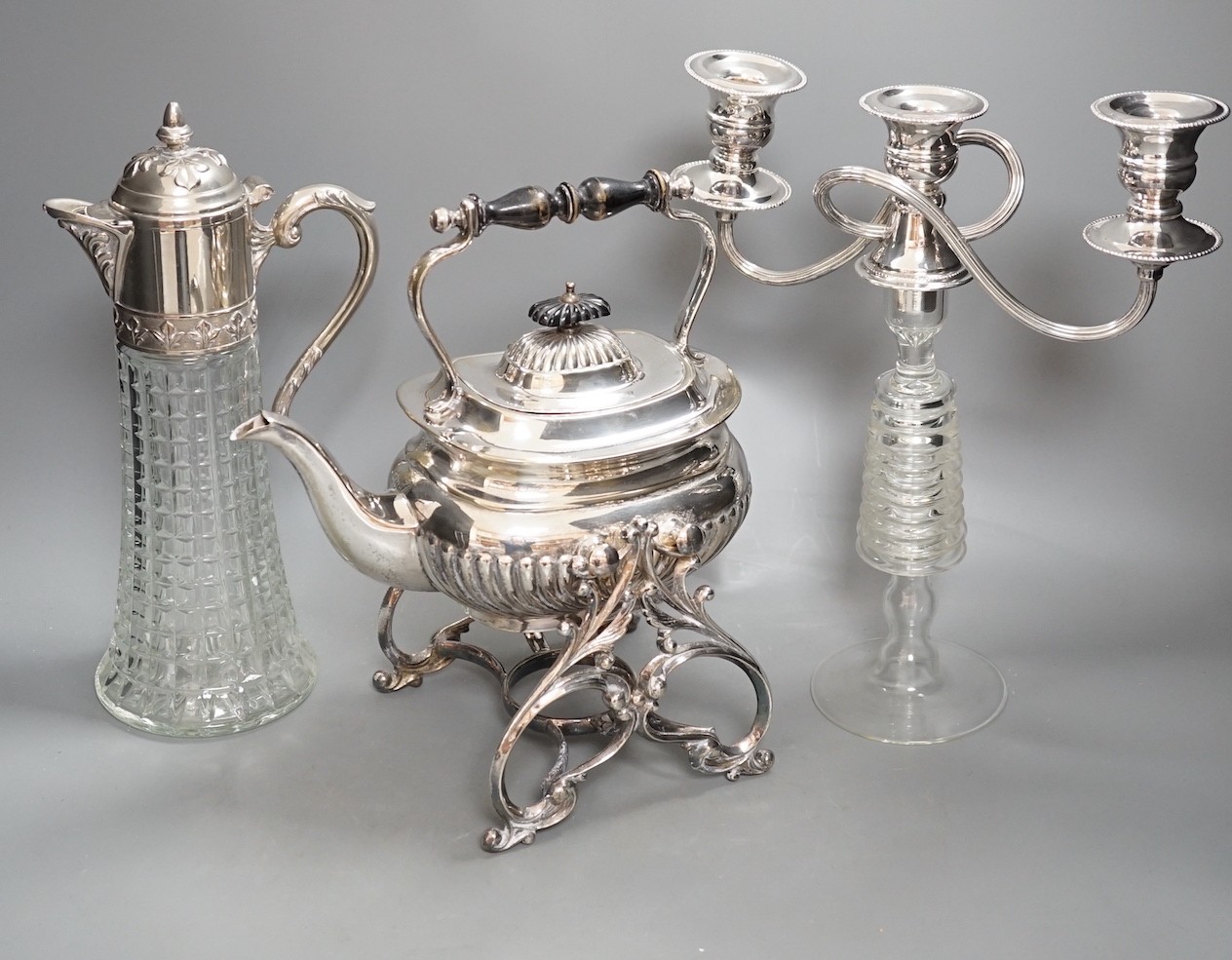 Plated tea kettle, claret jug and a candelabrum - tallest 31cm